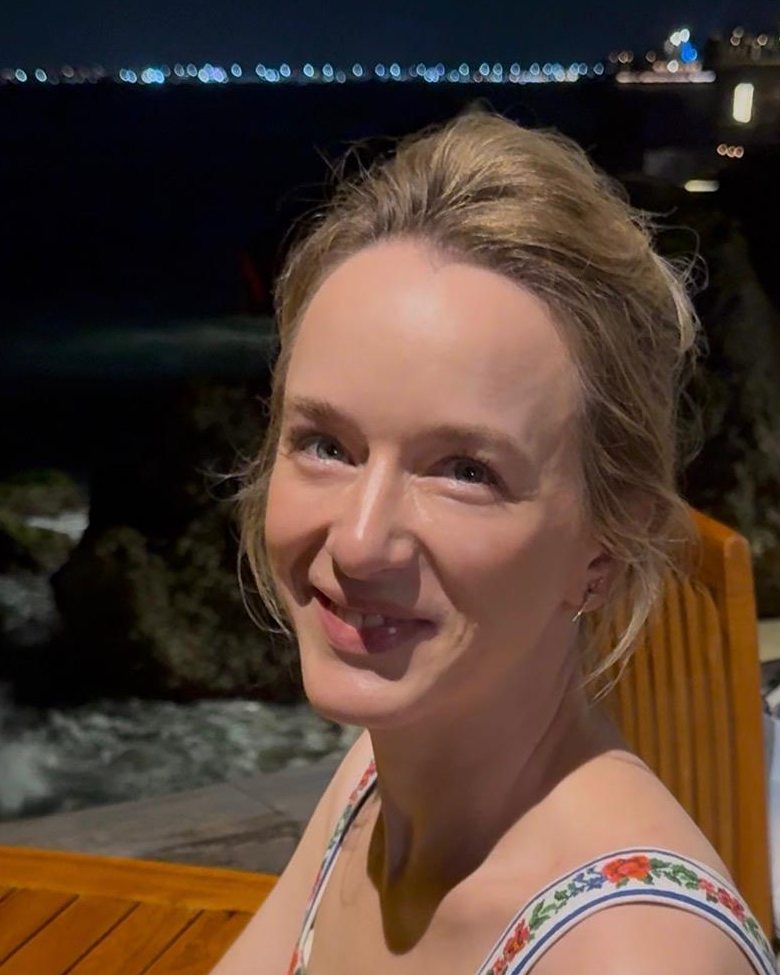 Sofia Lesin, smiling, photographed outdoors in the evening.